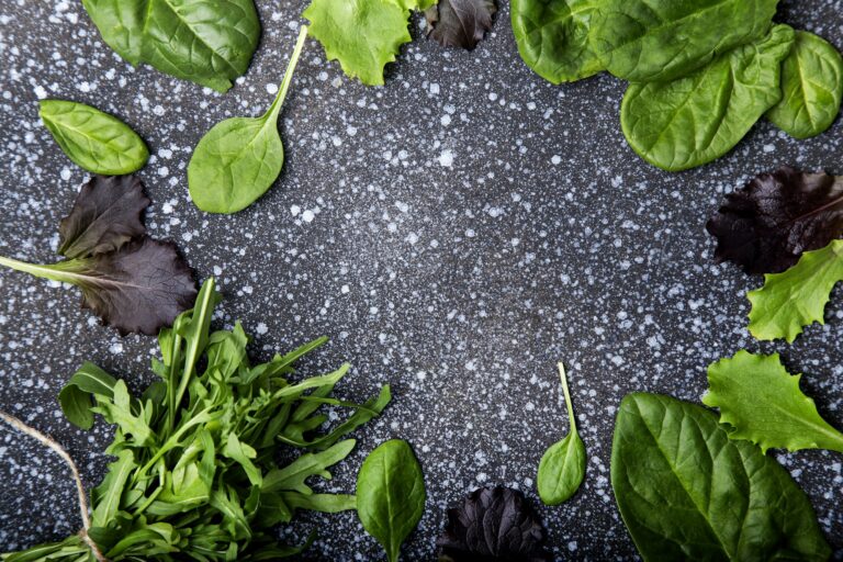 Fresh Mixed Greens on Textured Background - A Plant-Based Diet Staple