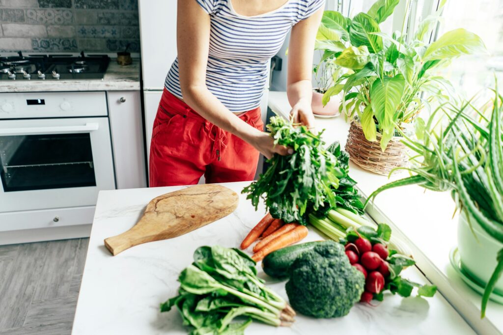 Healthy lifestyle. Cooking salad and smoothie from fresh herbs and vegetables.