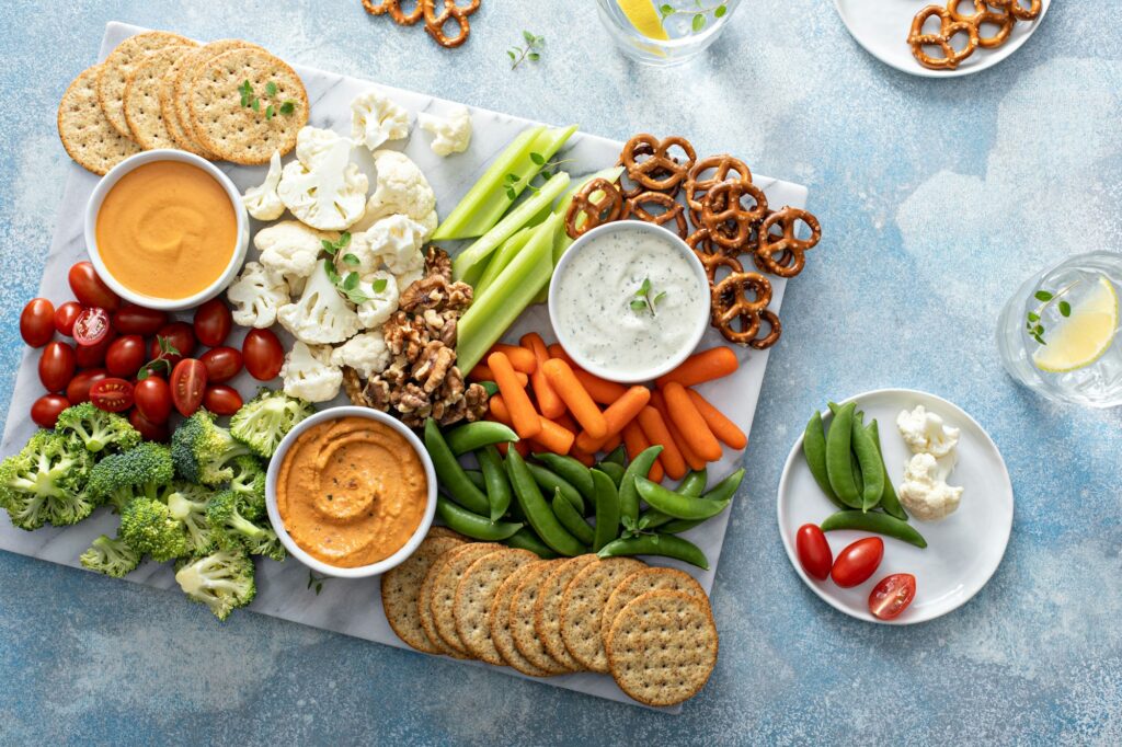 Plant based snack board with vegetables and crackers
